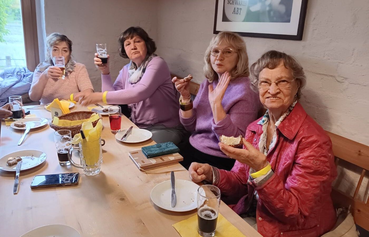 Vier Frauen der AWO-Gruppe stoßen bei einer Brauereiverkostung lachend an